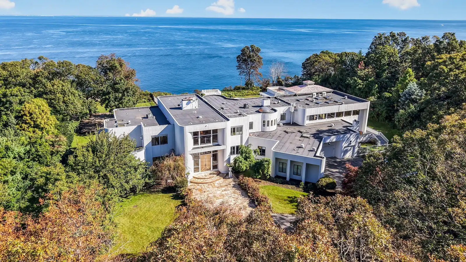 157 Cliff Road from the air: the white house above the bluff, with Long Island Sound beyond
